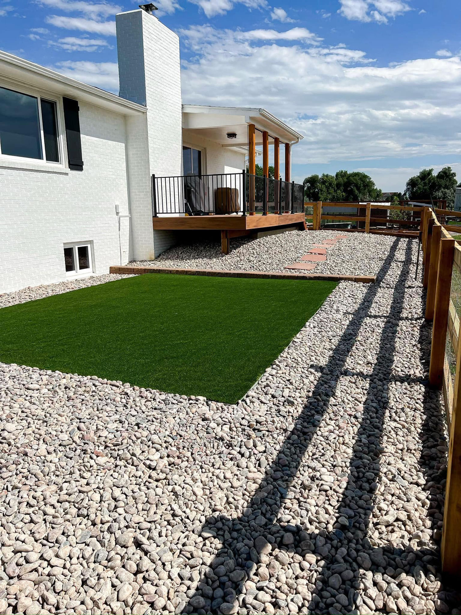 Turf and rock landscaping with deck